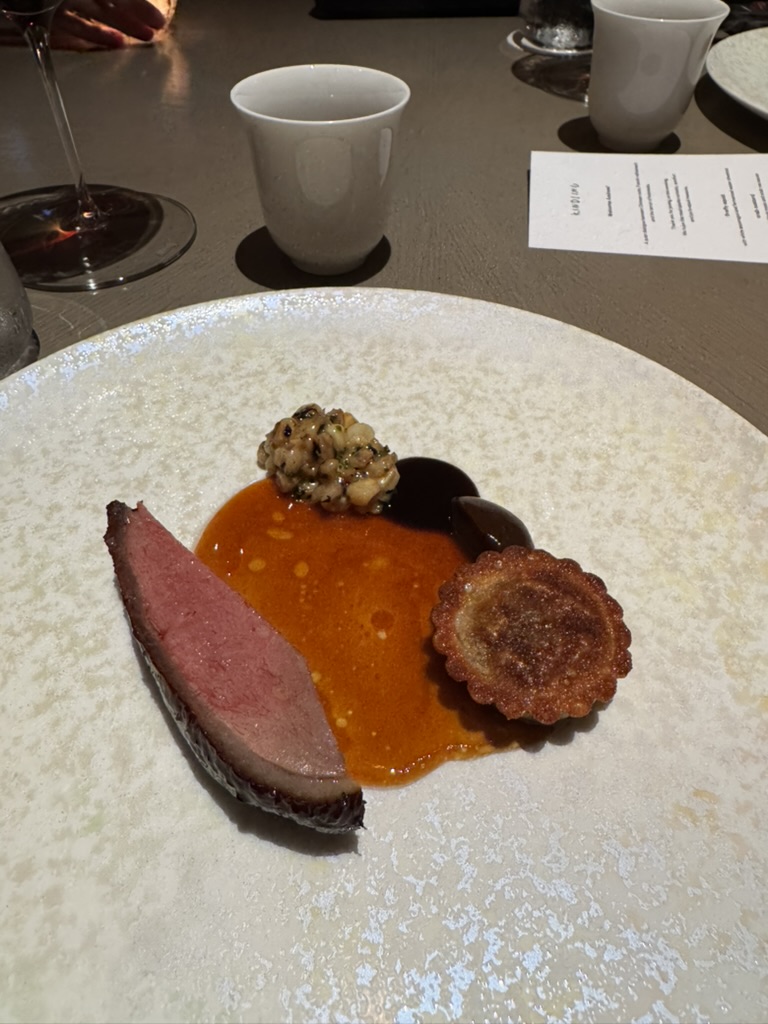 Duck course with orange sauce and a small tart