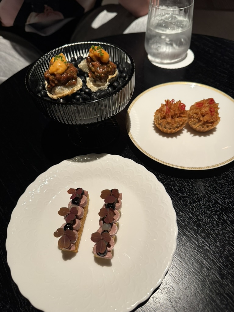 Kindling small bites served on white plates and a black table