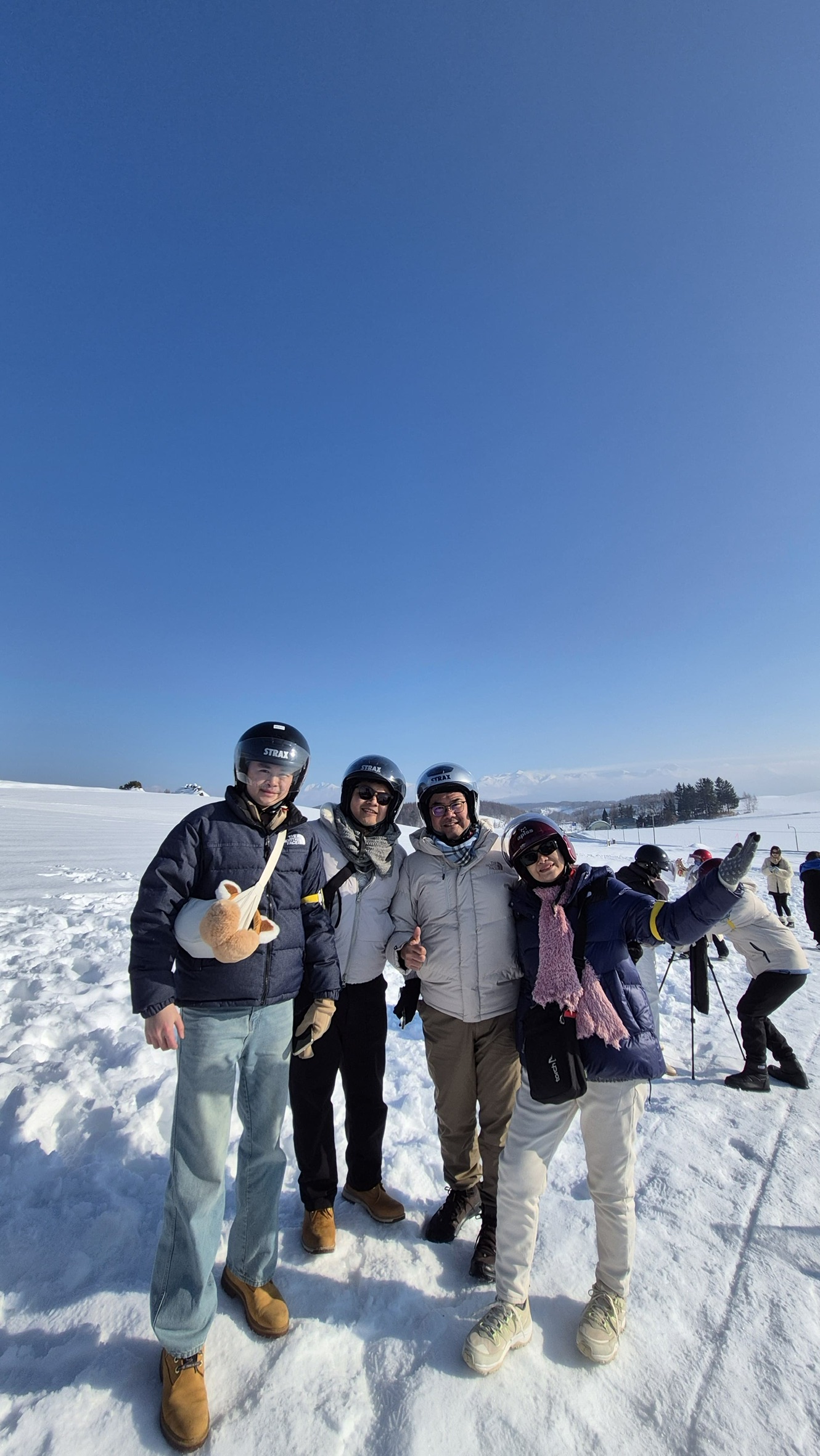 Family group photo after snow ATV riding in Biei