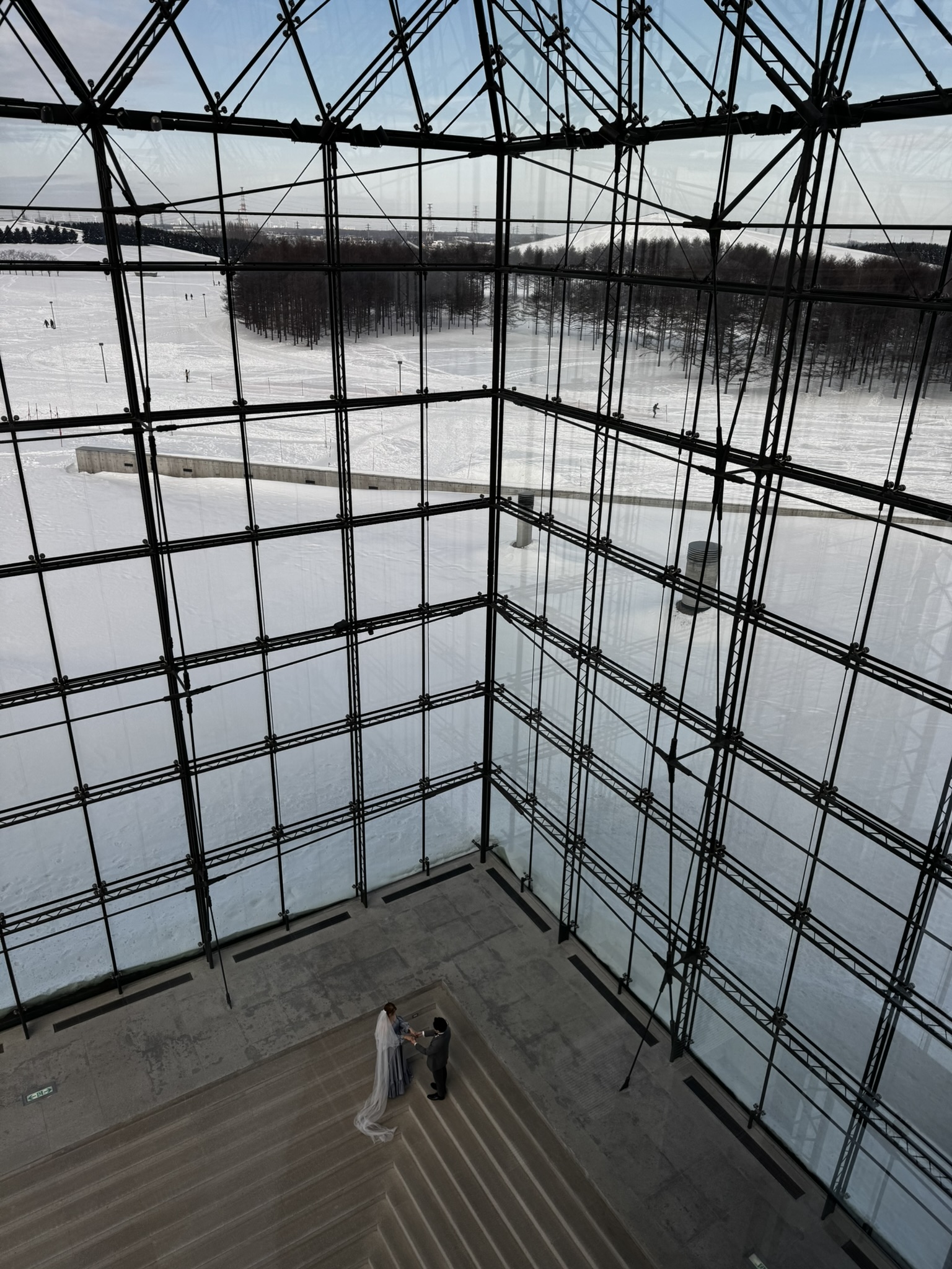 Snowy view through the glass pyramid structure