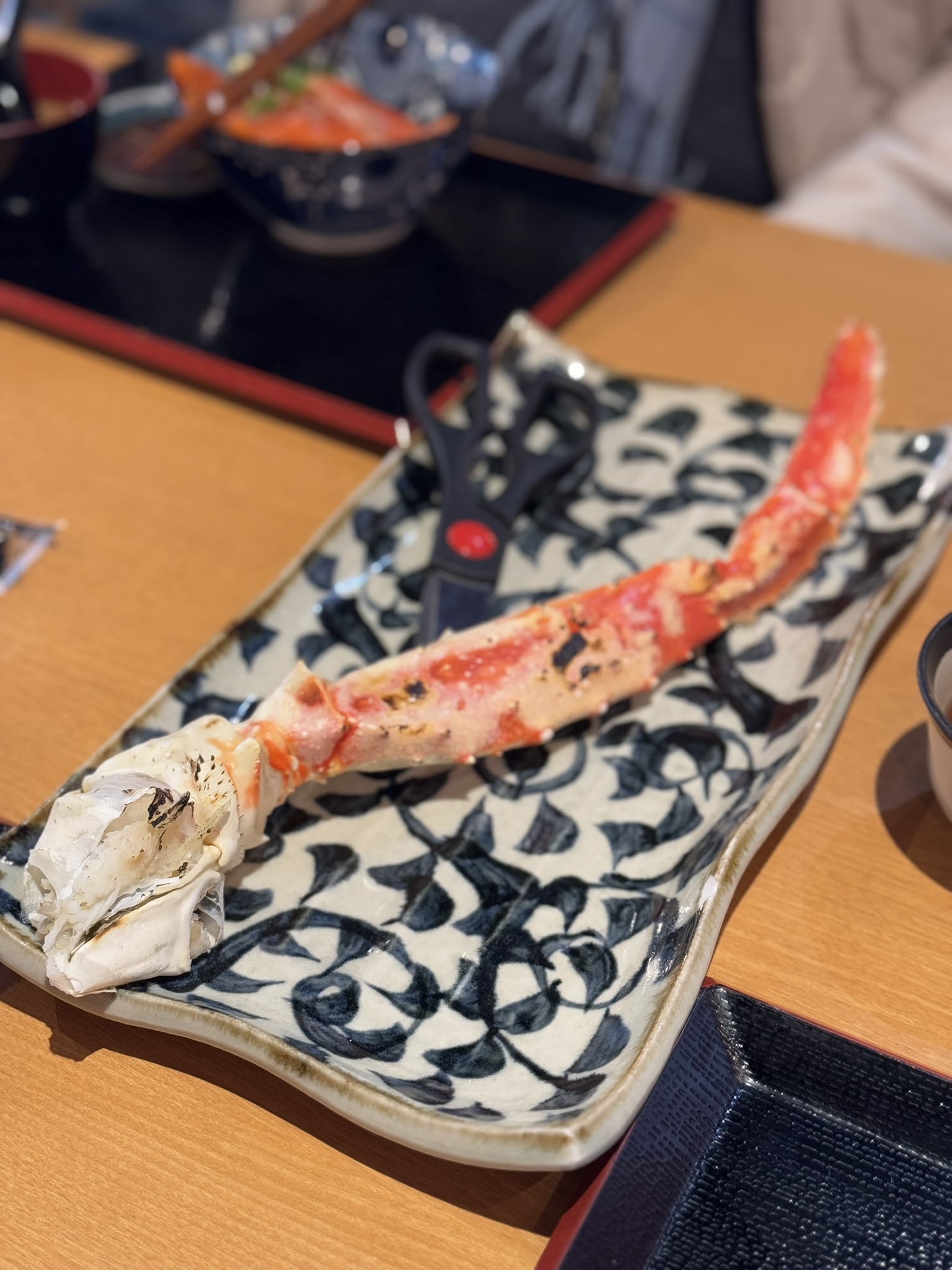Juicy king crab leg served on a patterned plate