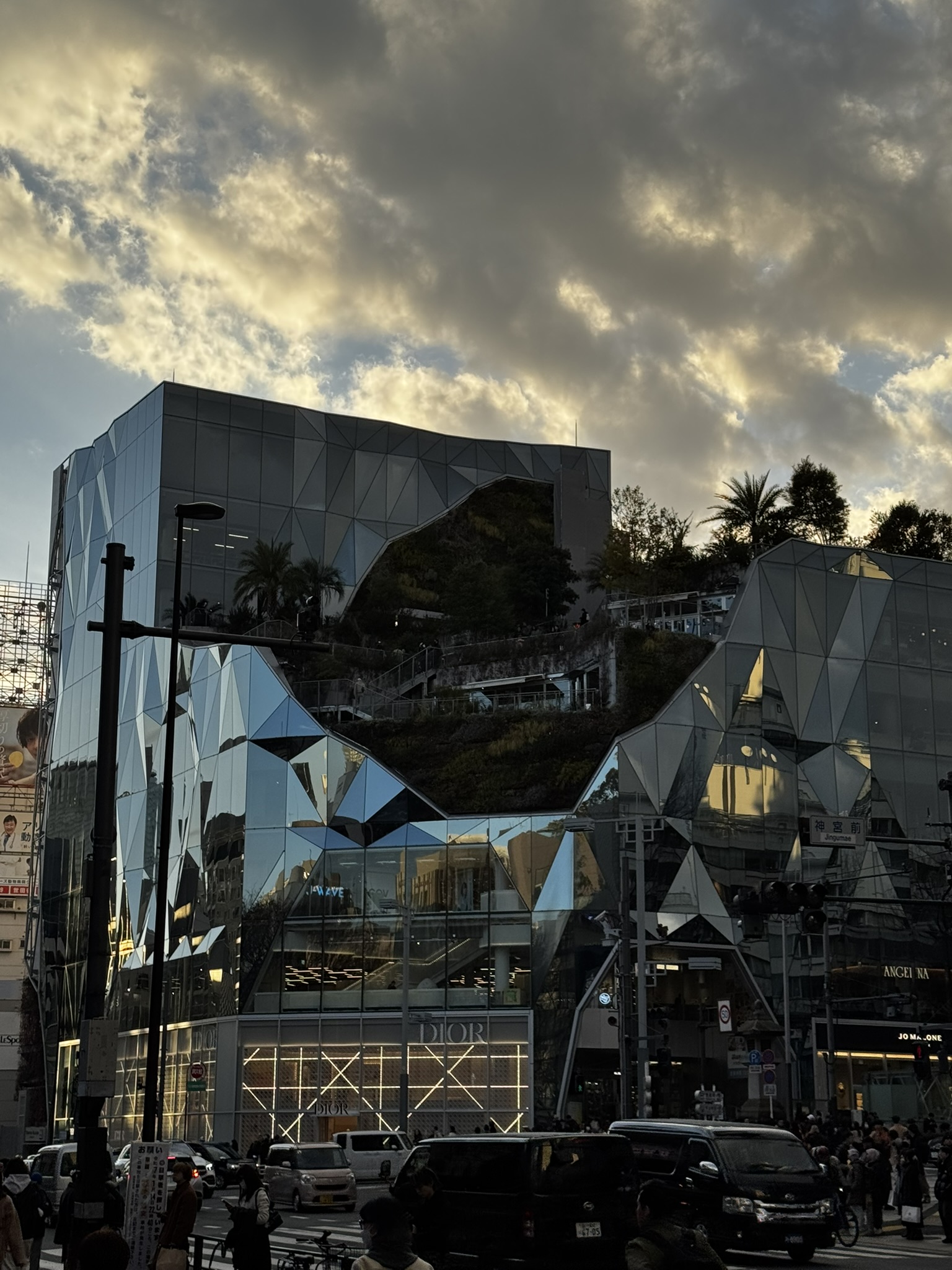 Mirror-like building in Harajuku and Omotesando glowing under sunset clouds