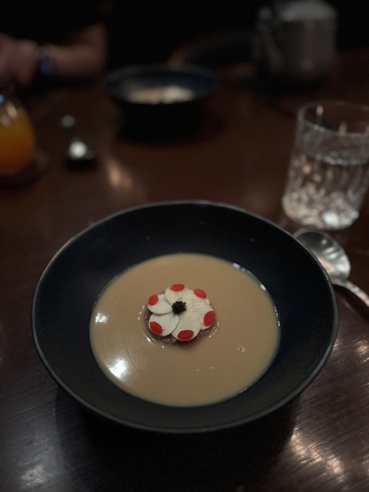 Saawaan Charcoal course in a dark bowl with a composed center garnish