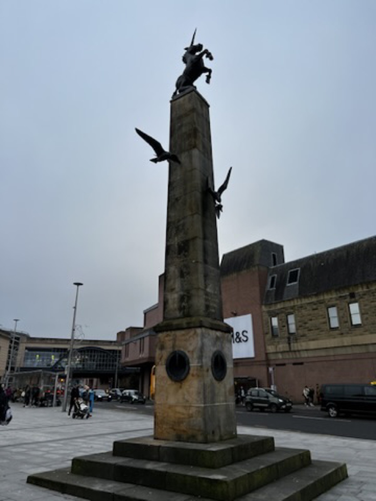 Stone monument in Inverness under a grey sky